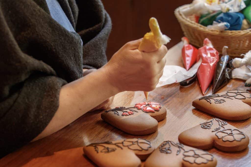 Woman decorating cake, Christmas decorations, Christmas cake