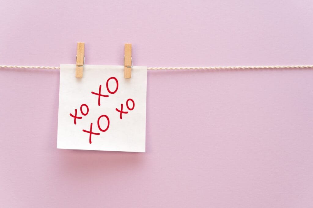 White sticker on a rope with a clothespin with an inscription